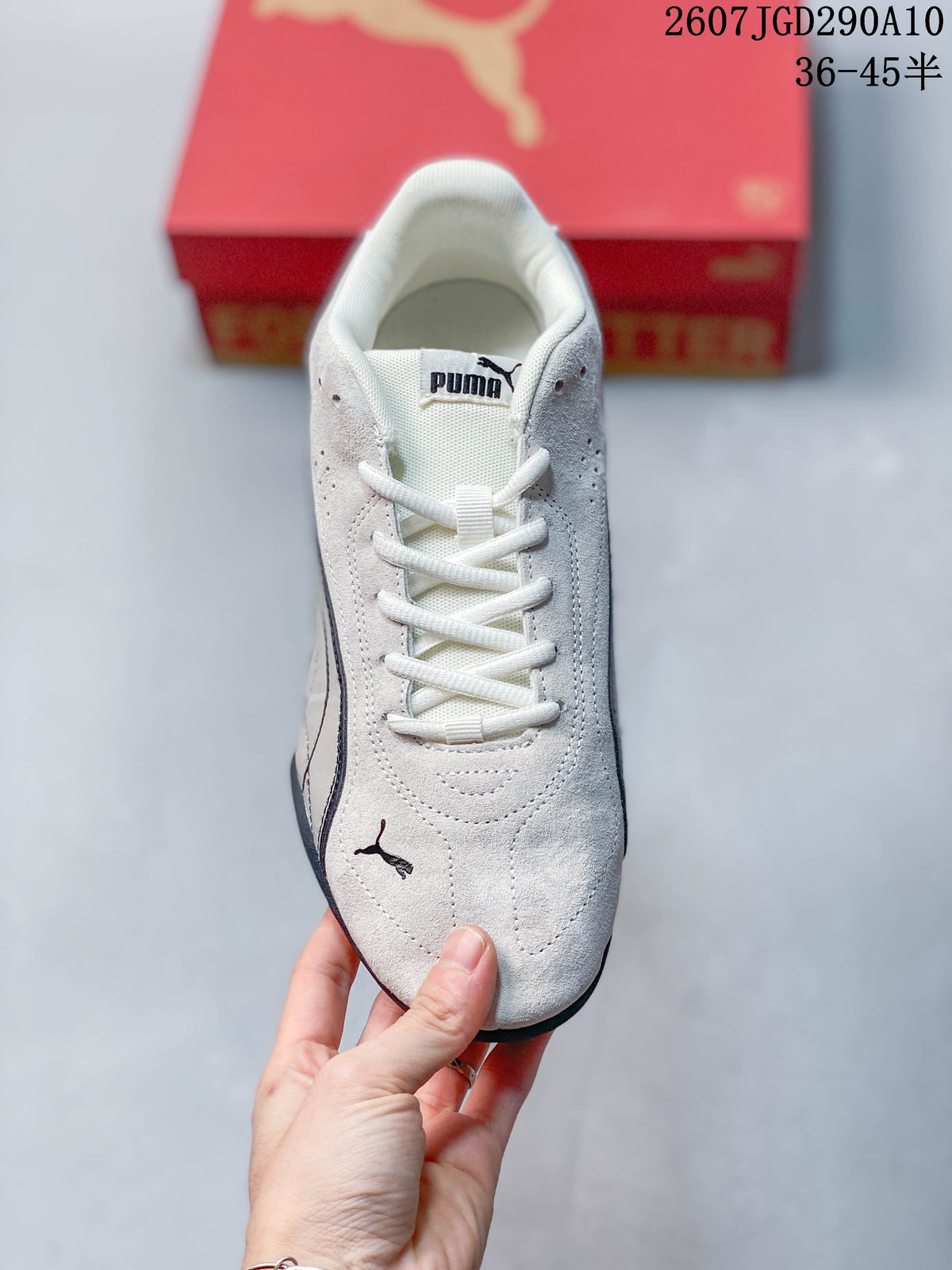 Top view of the white lace-up sneaker showing the tongue, eyelets and perforated panels.