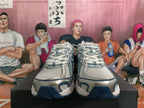 Front view of white and blue New Balance sneakers