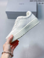 Side view of the white sneaker showing the panelled upper, padded collar, and thick tonal outsole.
