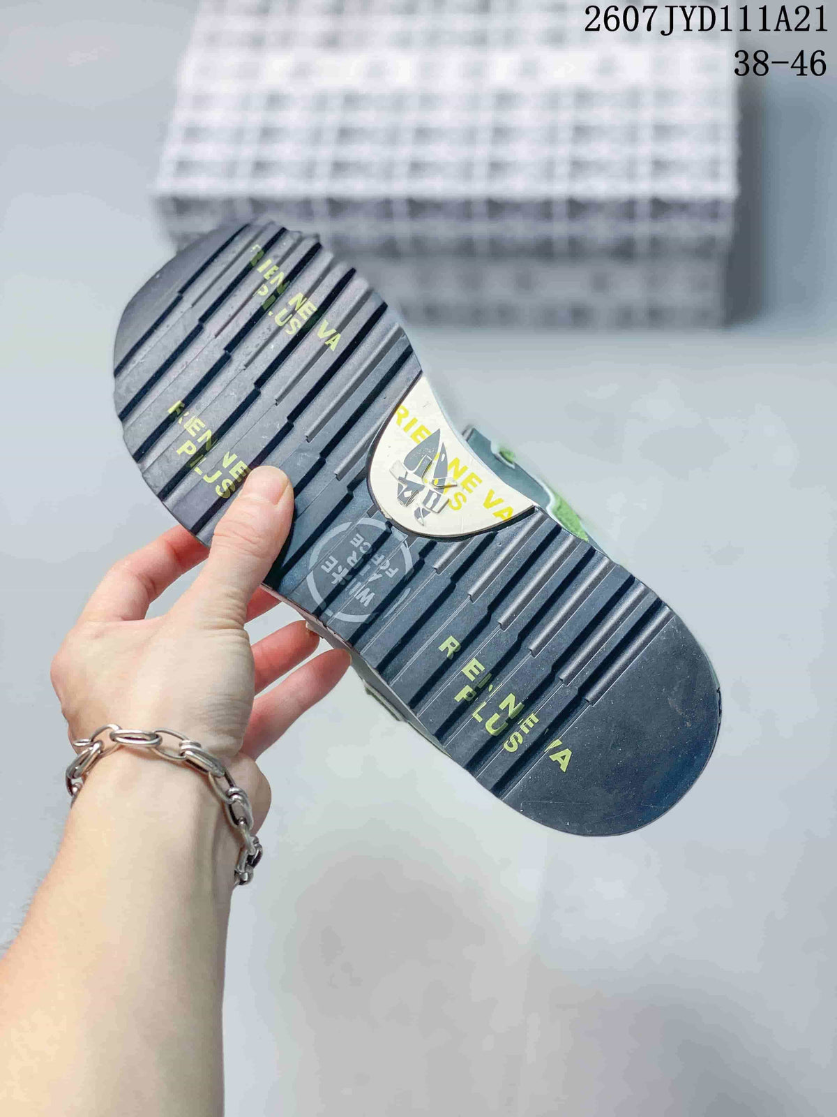 Close view of the sneaker outsole showing black tread grooves and printed graphics.