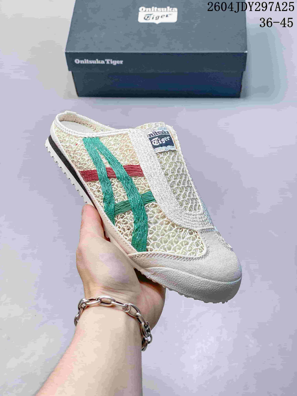 Angled view of one cream Onitsuka Tiger Mexico 66 Sabot sneaker with green and red stripes and an open-heel design.