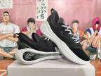 Two black basketball sneakers with white soles shown from side and three-quarter angles.