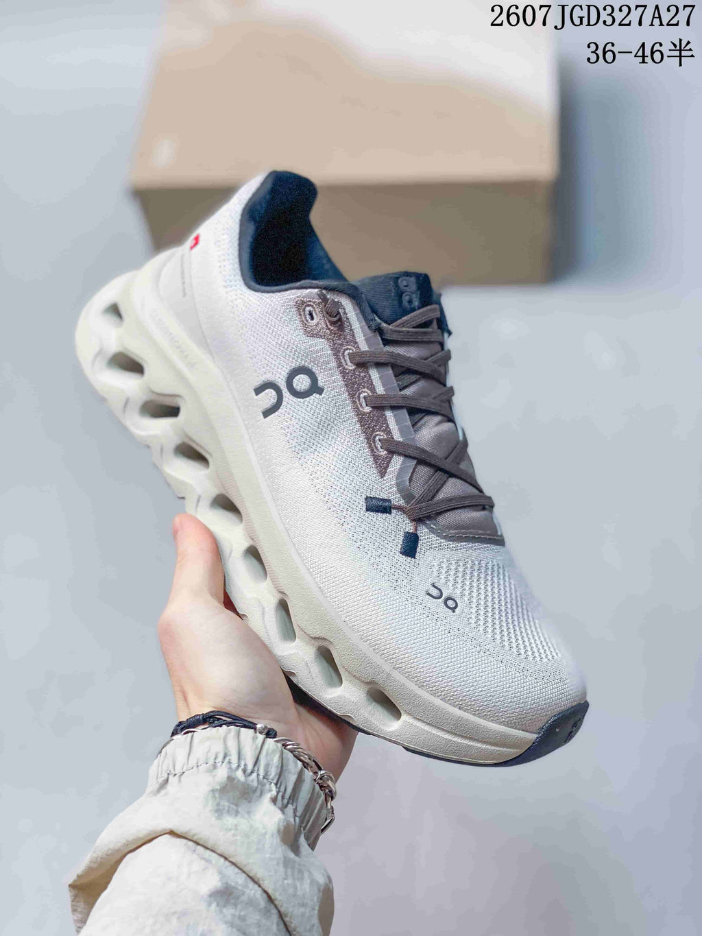Angled side view of the On sneaker showing the white upper, dark laces, On logo, and sculpted sole.