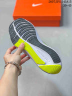 Close view of the Nike Zoom Winflo 8 outsole showing black tread sections, lime green traction areas, and a white midsole.