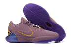 Muted purple Nike basketball shoes with yellow accents and purple outsoles.