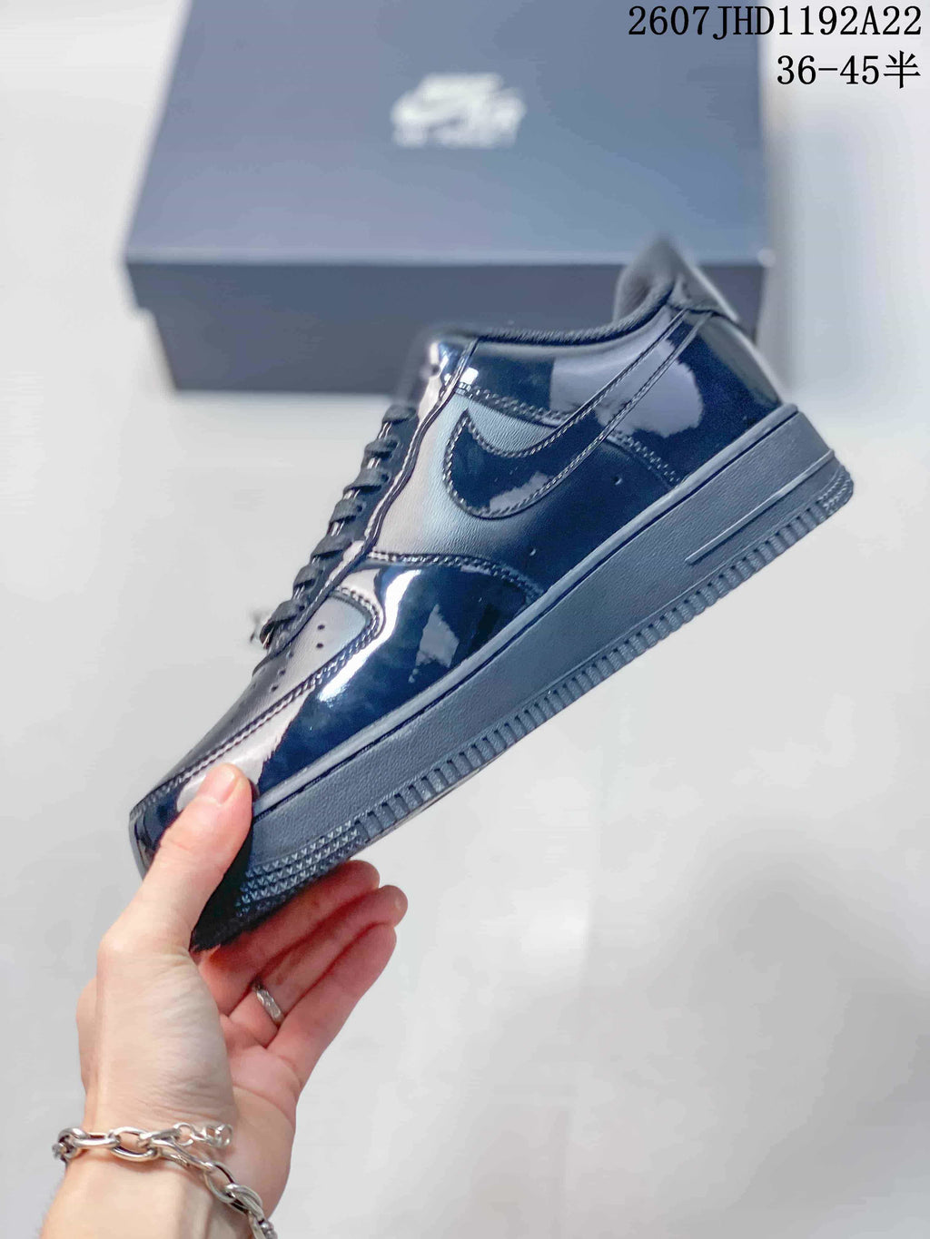 Side profile of the black low-top sneaker showing the swoosh panel, layered upper and cupsole construction.