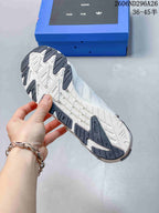 Underside view of the sneaker showing the white and dark patterned outsole.
