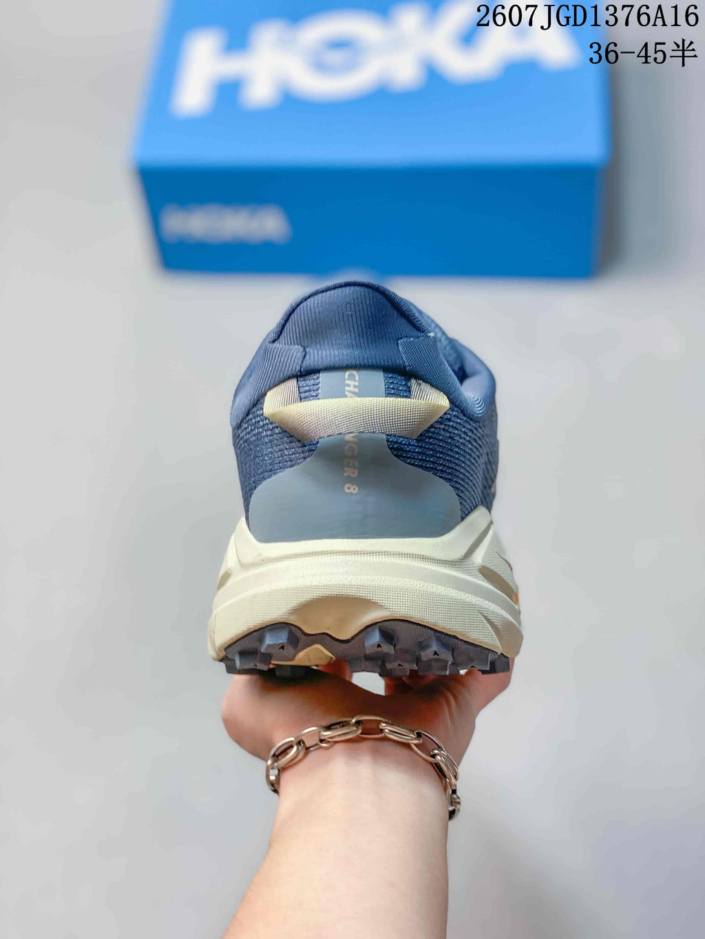 Rear view of the blue running shoe showing the padded heel collar, cream midsole and outsole sections.