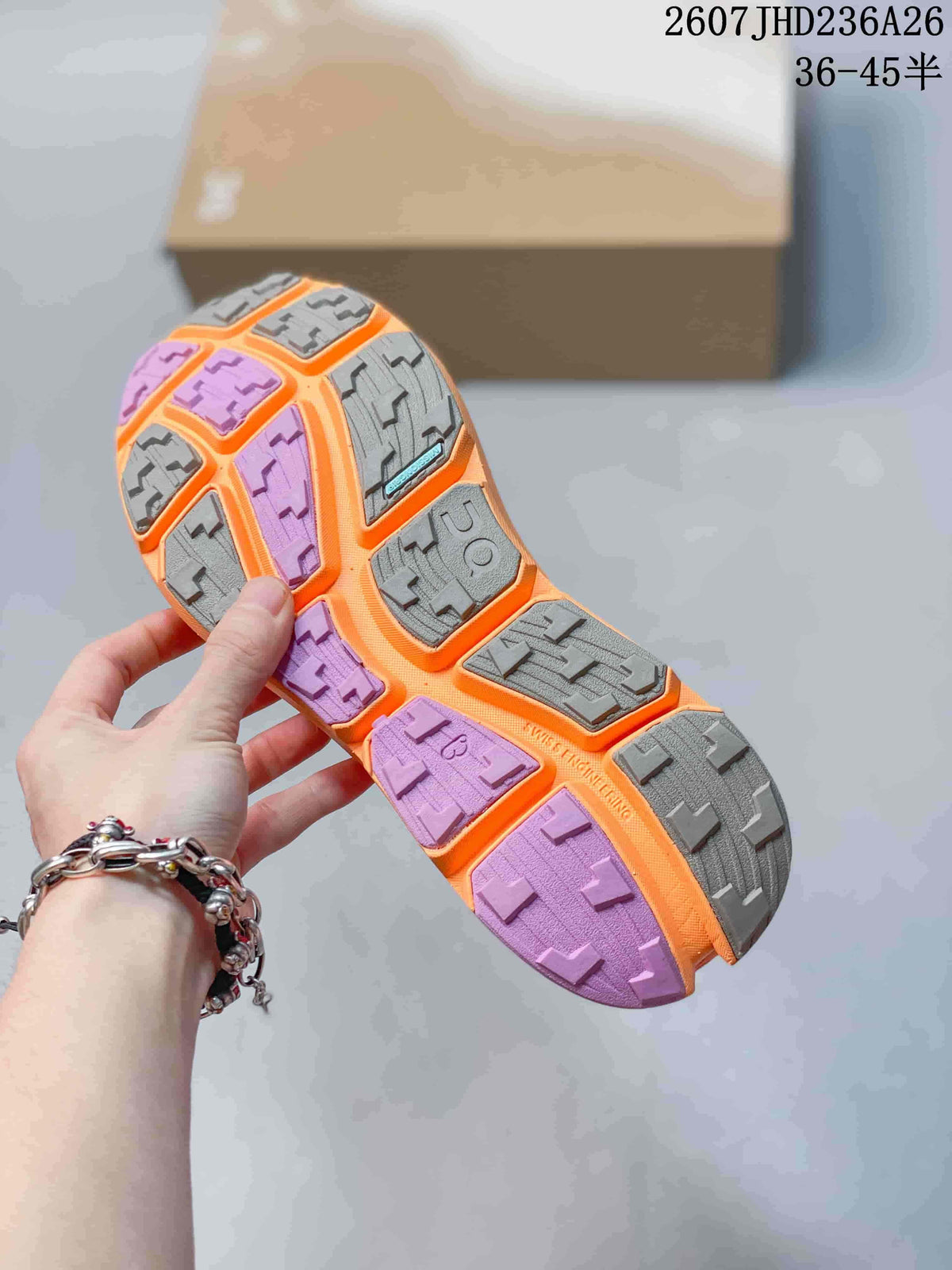 Close view of the shoe outsole showing gray and purple lugged rubber sections.