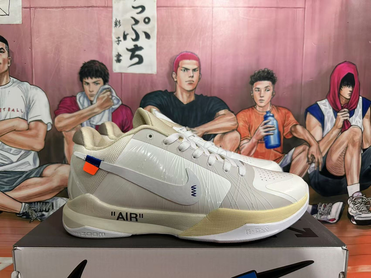 Side view of a pale cream basketball shoe showing translucent side detailing, a small orange-and-blue tab, and AIR midsole text.