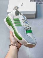 Angled side view of a Y-3 Rivalry sneaker with green stripes and light-blue panels