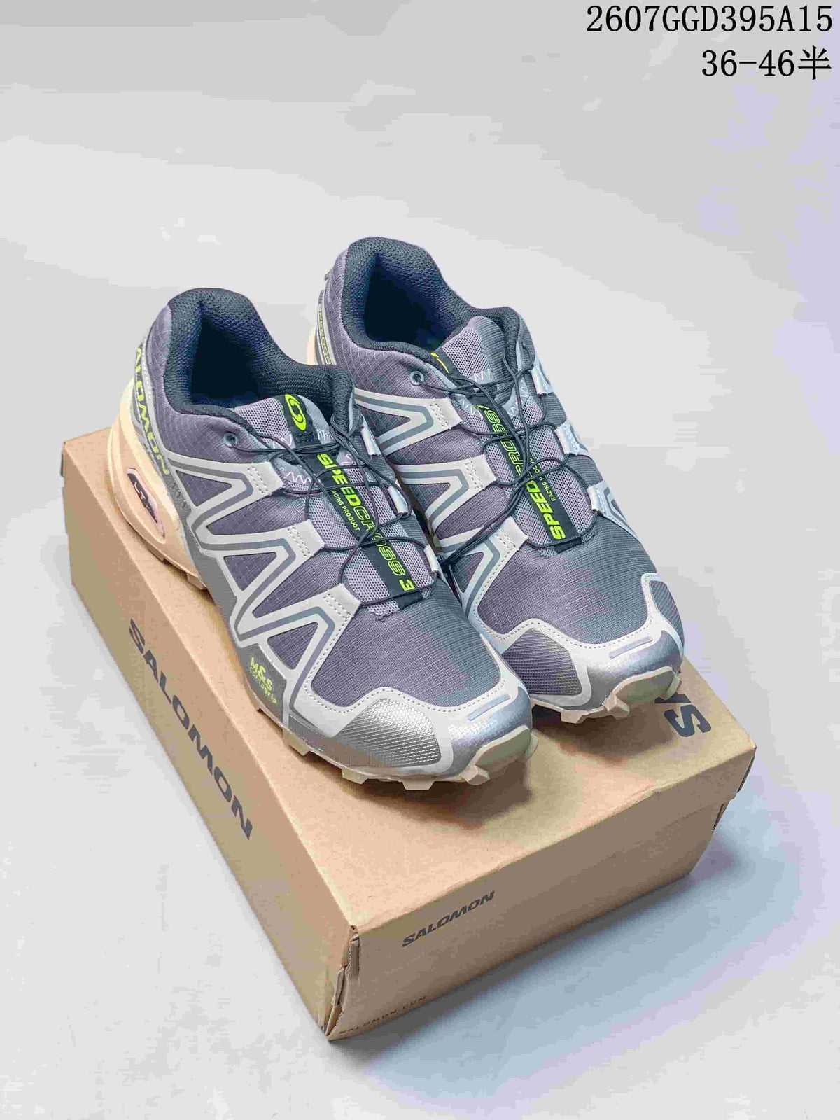 Pair of gray and silver Salomon SPEEDCROSS 3 shoes with lime accents displayed on a branded shoe box.