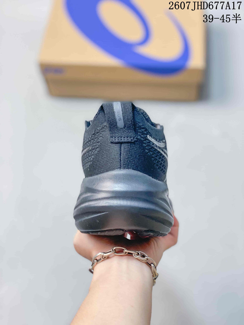Rear view of a black ASICS running shoe showing the padded heel collar and layered sole.