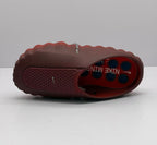 Top view of a dark red slip-on sneaker with a perforated upper panel and patterned insole.