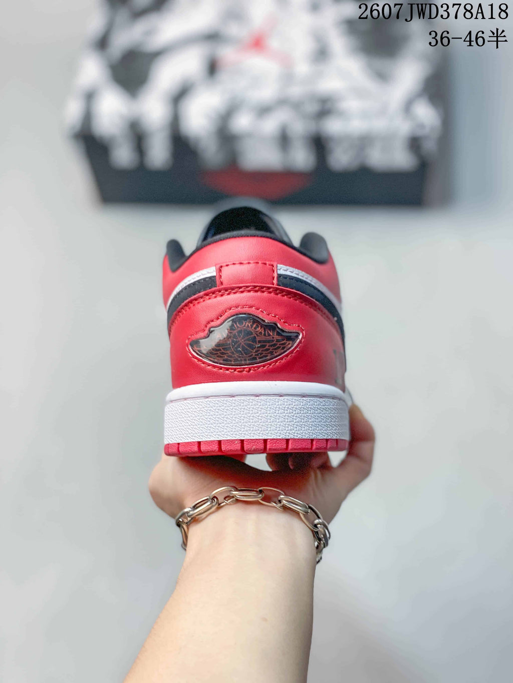 Rear view showing the red heel panels, black detailing, and white midsoles
