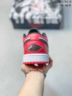 Rear view showing the red heel panels, black detailing, and white midsoles