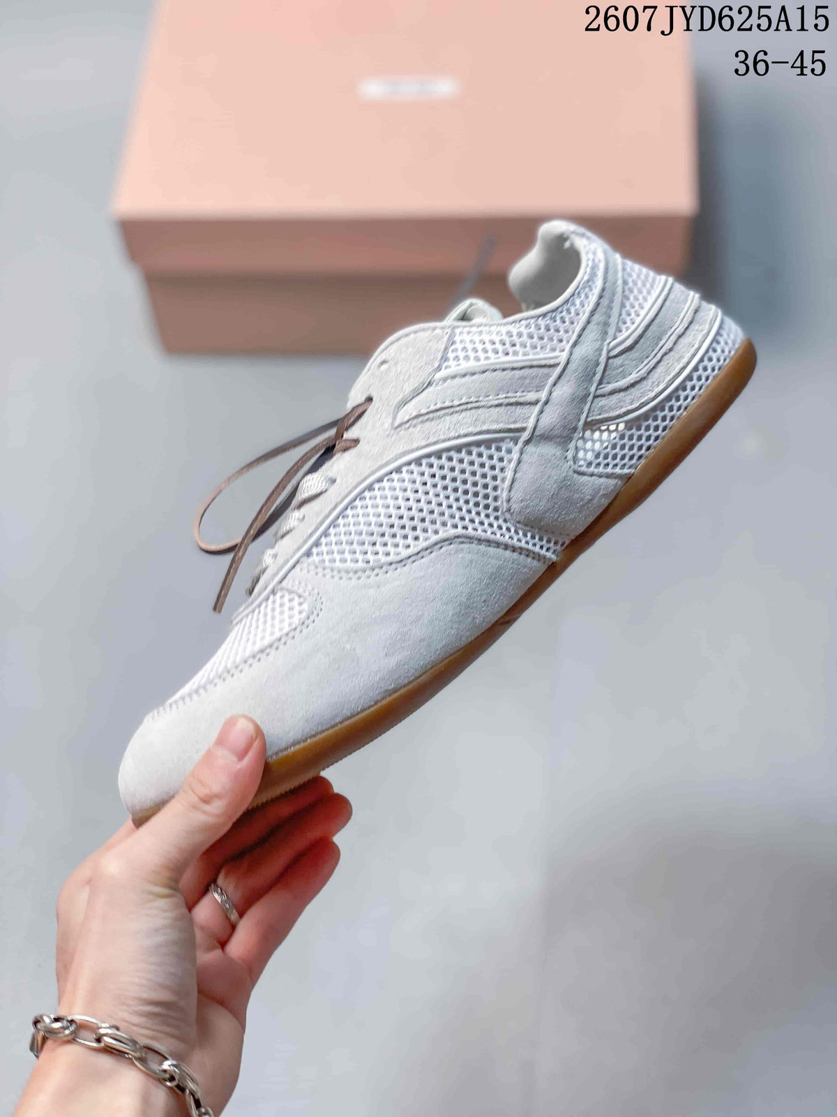 Side view highlighting the white and grey layered upper, mesh panels, low-top profile, and gum-colored outsole.