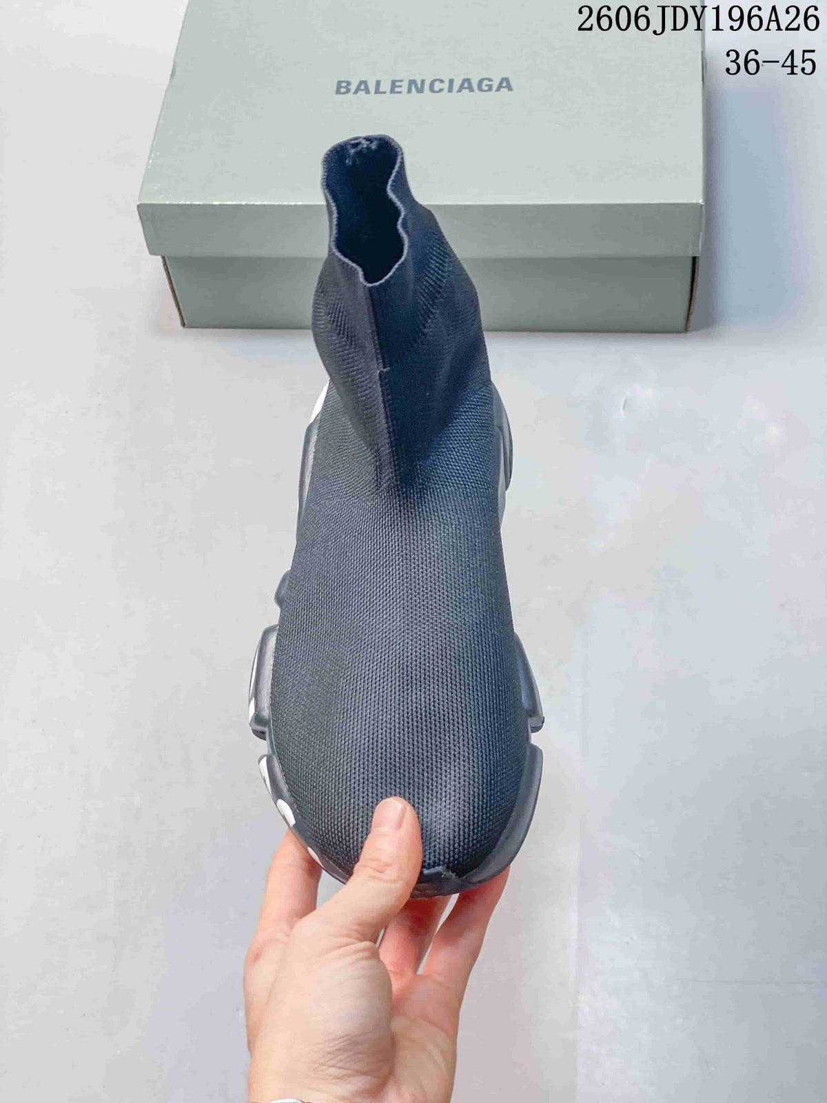 Top view of a dark gray sock-style sneaker showing the streamlined knit upper and elastic-looking collar opening.