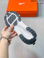 Outsole view showing the white midsole and patterned black traction sections with Storm-Tread text.