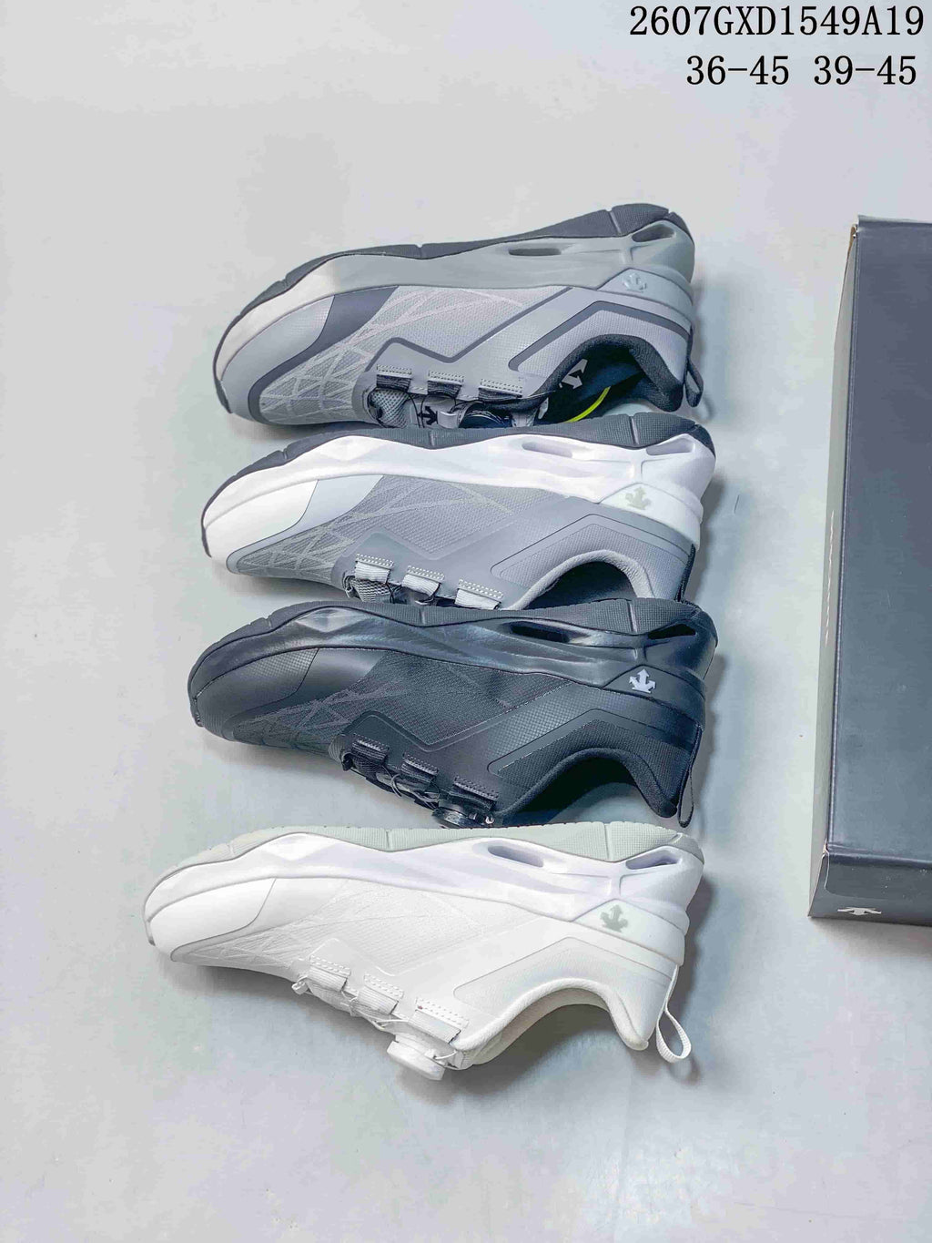 Several color options of the DESCENTE Circuit 2.0 Wire shoe arranged beside the shoebox, including black, gray and white versions.