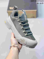Three-quarter view of a gray The North Face trail sneaker showing the branding, lace closure, padded collar and rugged outsole.