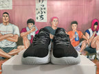 Front view of black basketball shoes with patterned laces and gray soles.