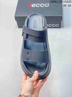 Top view of a dark gray sandal showing the open toe, two broad straps, and textured footbed.