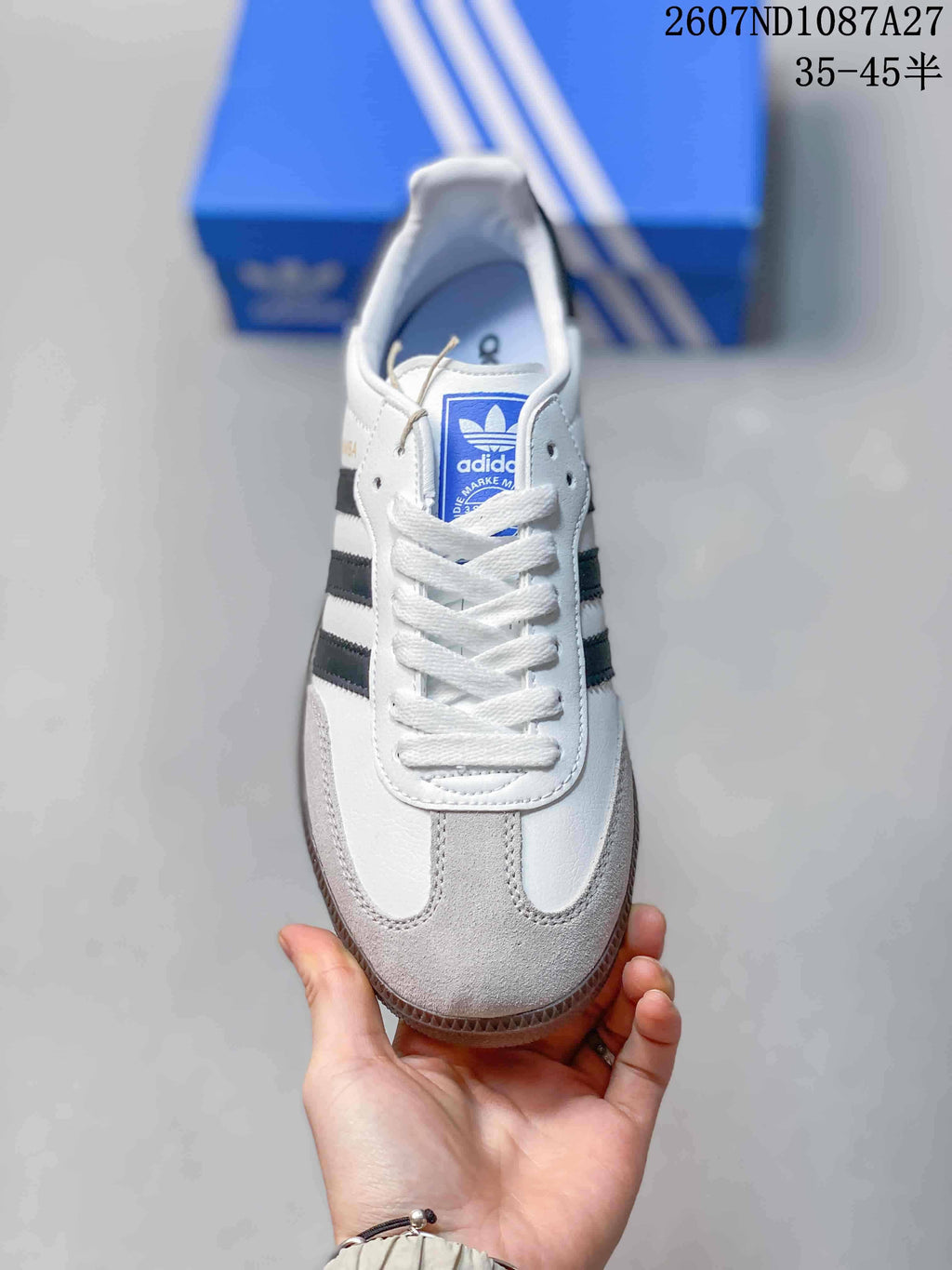 Top view showing the white laces, blue adidas tongue label and grey toe panel.