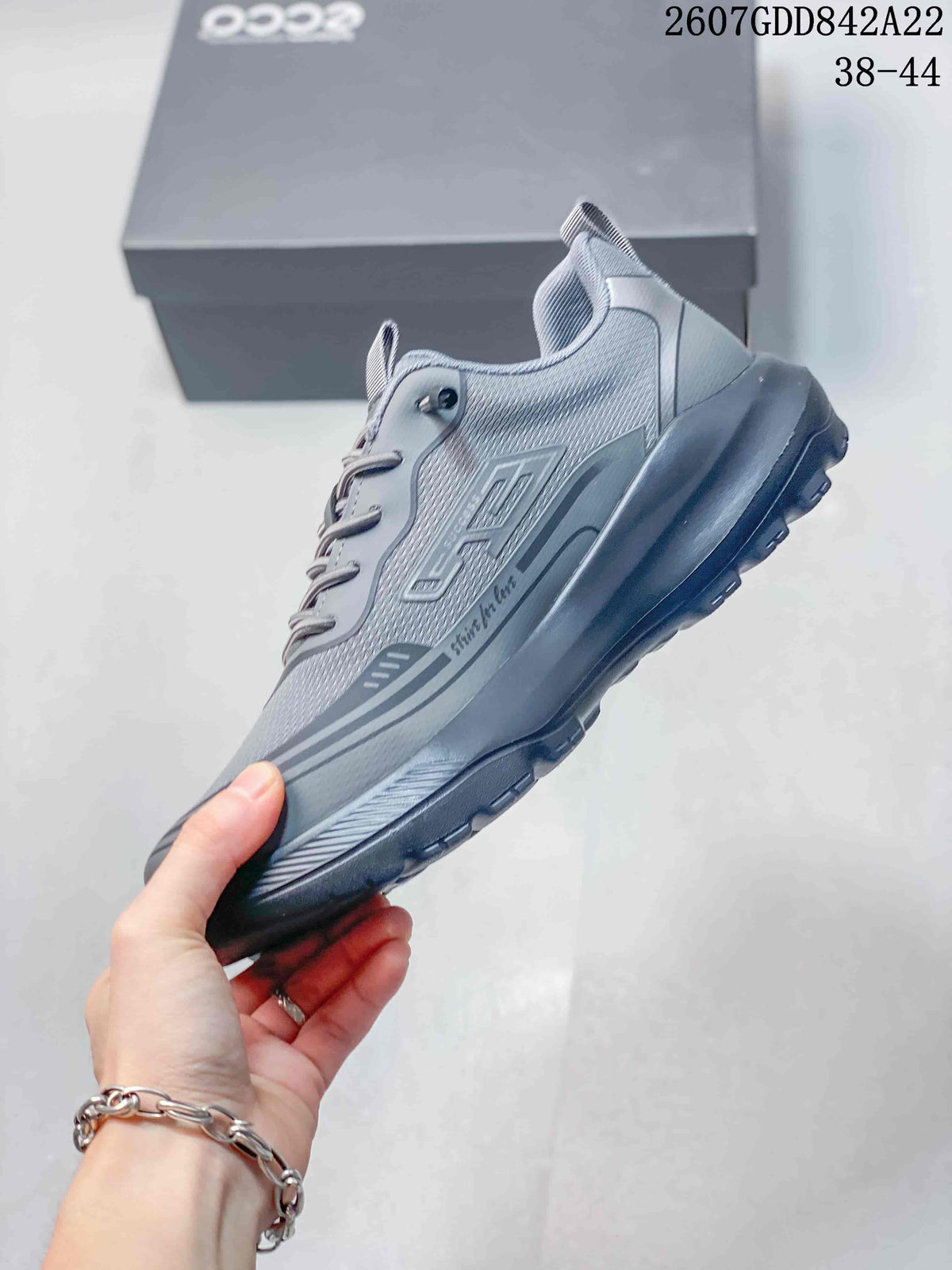 Side view of the gray ECCO sneaker showing layered overlays, mesh panels and the rugged sole.
