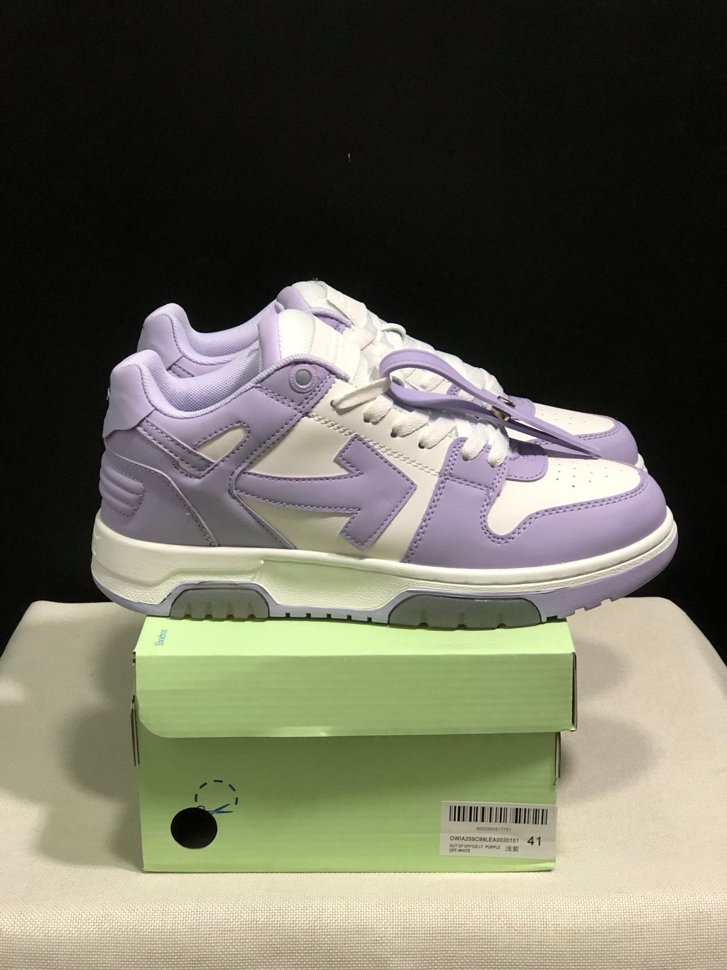 Side view of the lavender and white sneakers with contrasting panel details and layered outsole.