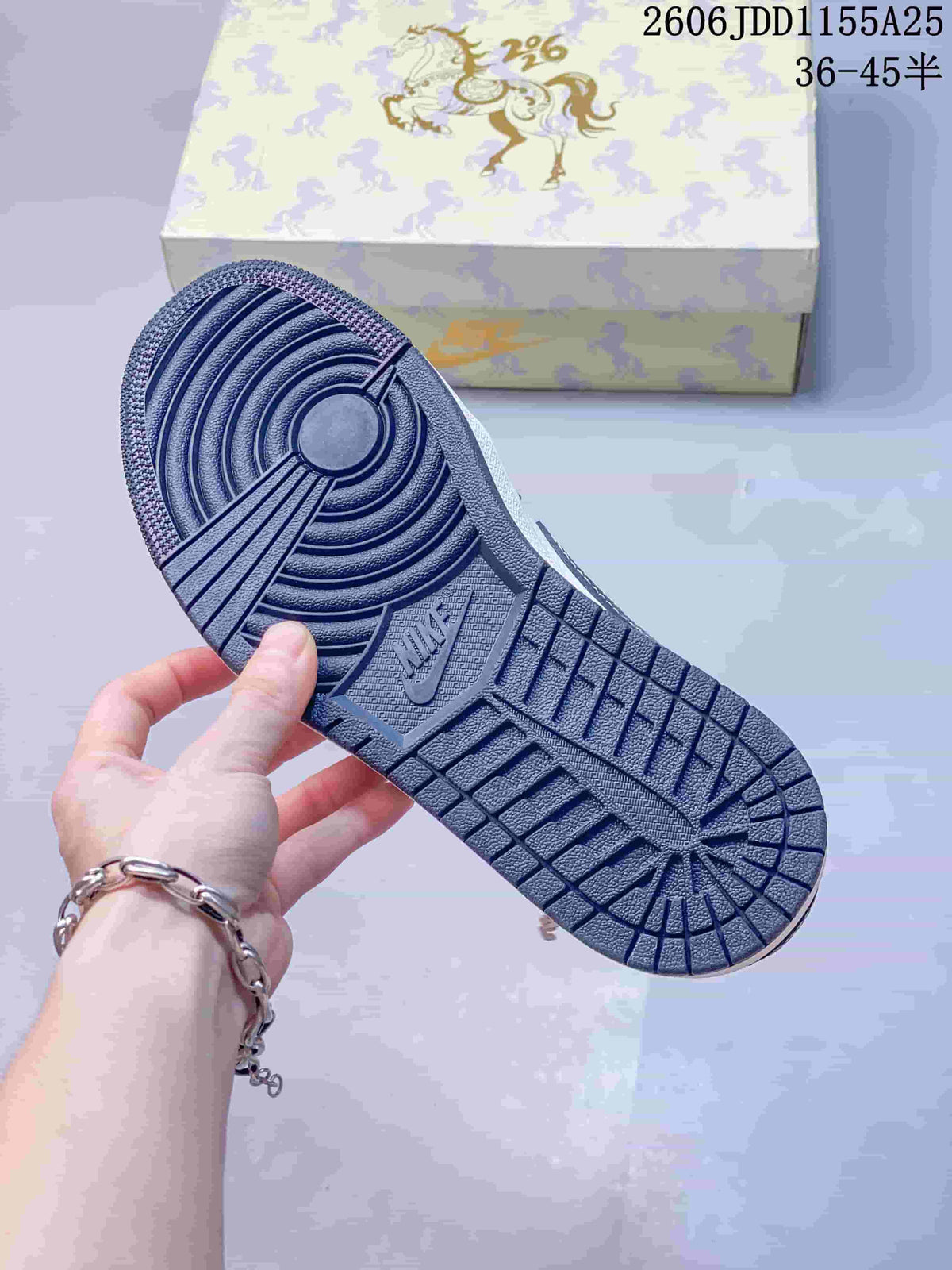 Close view of the dark rubber outsole showing circular and segmented traction patterns.