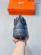 Rear view of the black sneaker showing the heel structure and pull tabs.