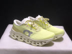 Three-quarter front view of the light yellow and white running sneakers.