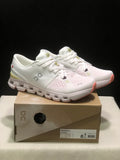 Pair of ivory and sand On Cloud X4 low-top running shoes displayed on a labeled shoe box.