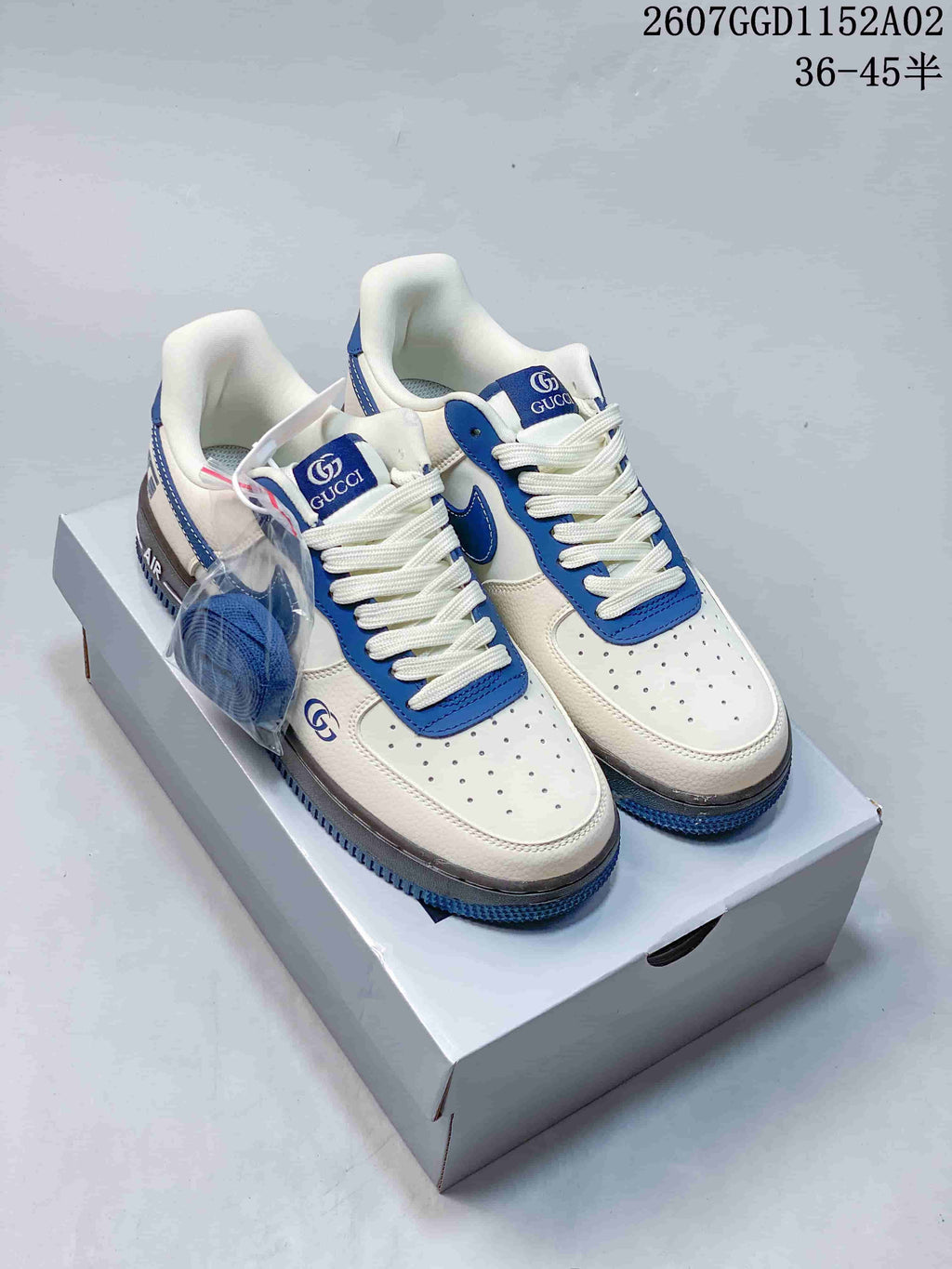 A separate blue-and-white low-top sneaker design with perforated toes and contrasting blue panels.