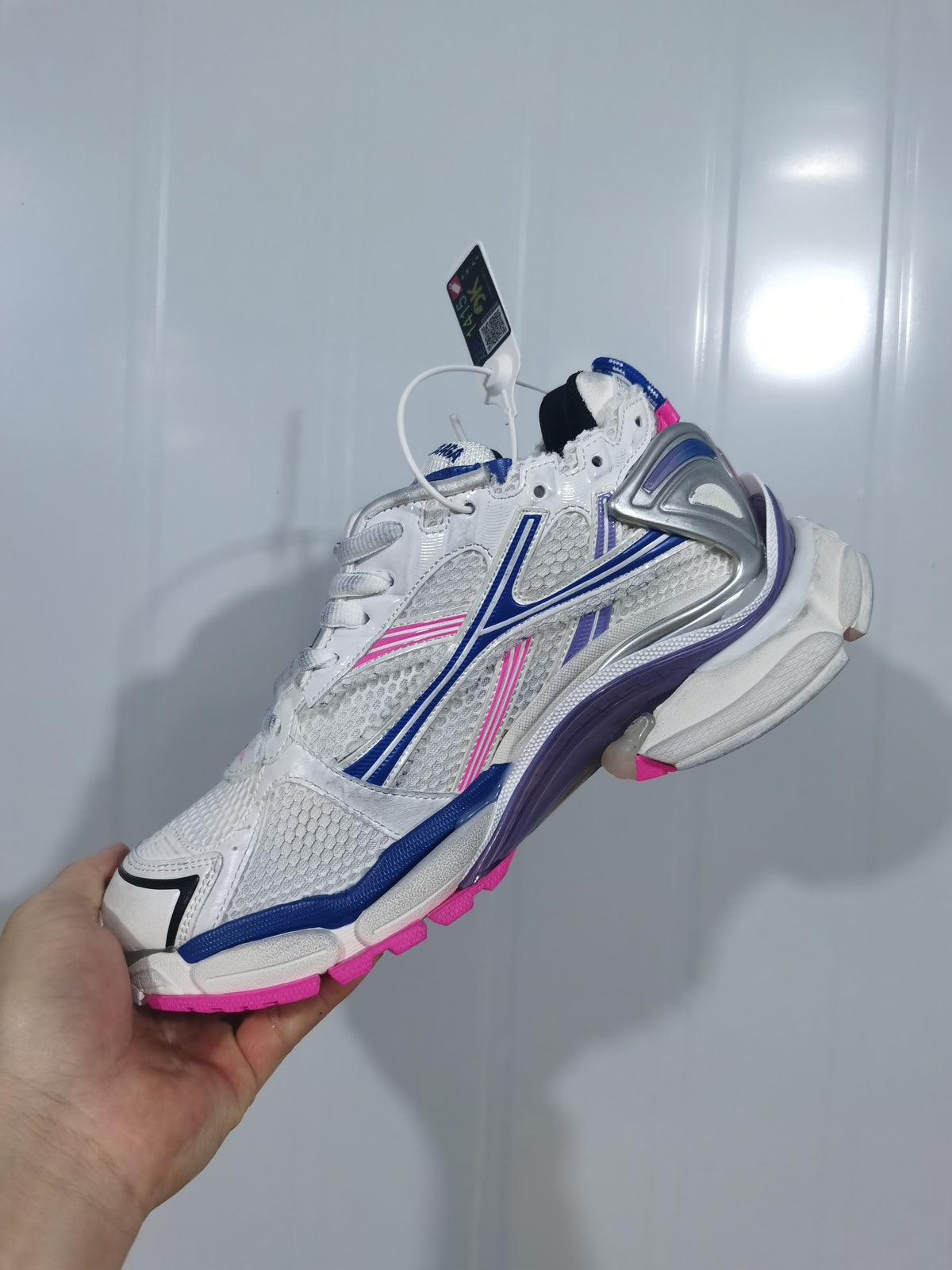 Side and outsole view of the Balenciaga 6120 runner sneaker with blue, purple, and pink detailing.
