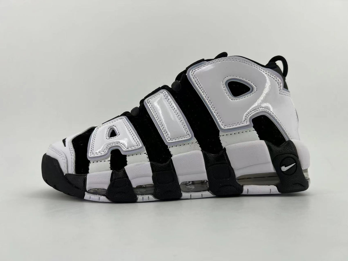 Black and white Nike Air More Uptempo sneaker with oversized side lettering and visible cushioning windows in the sole