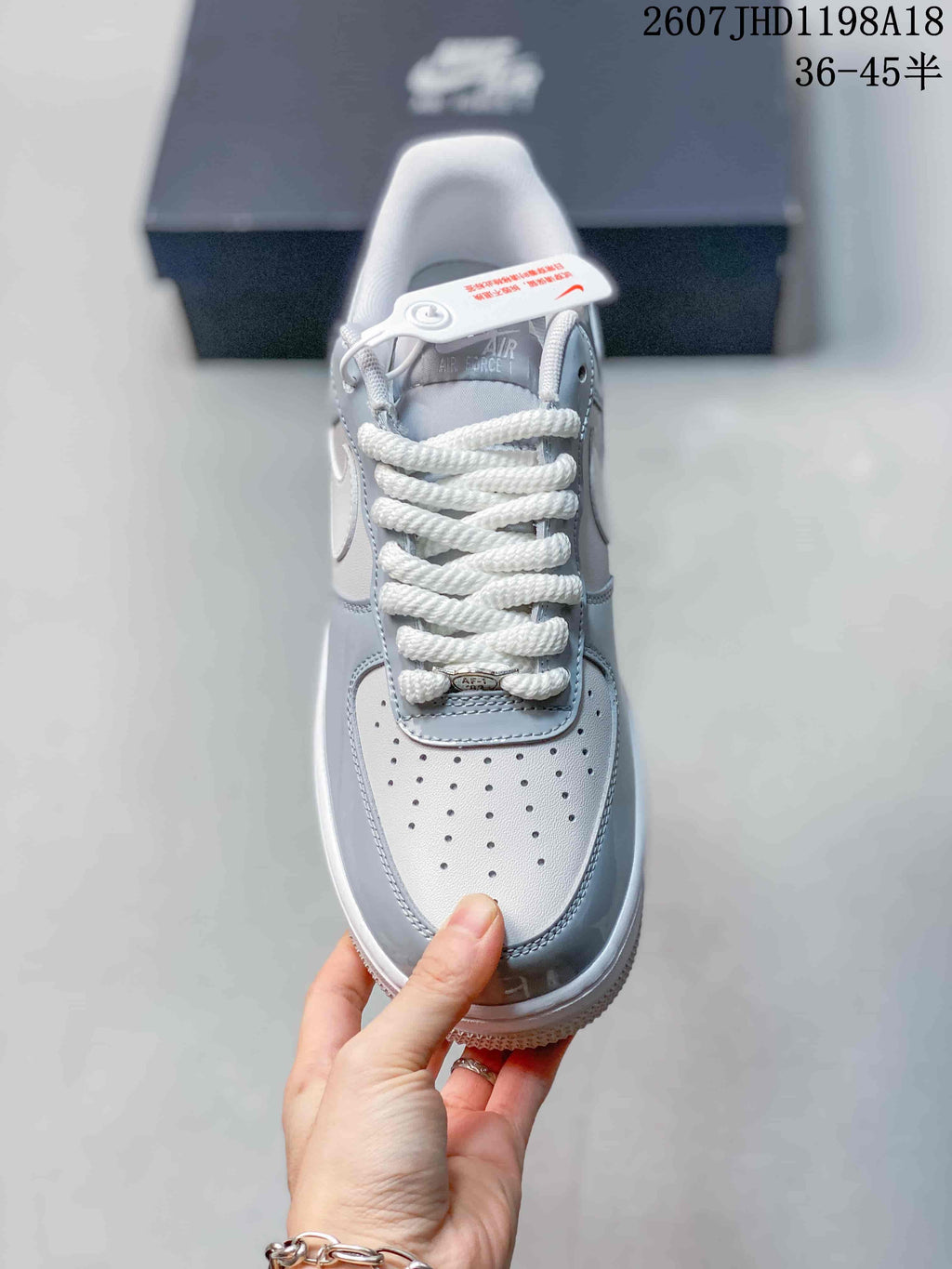 Top view of the sneaker showing the perforated toe box, white laces, and tongue branding.