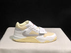 Single sneaker side profile highlighting the grey Swoosh, cream toe panel, strap and textured outsole.
