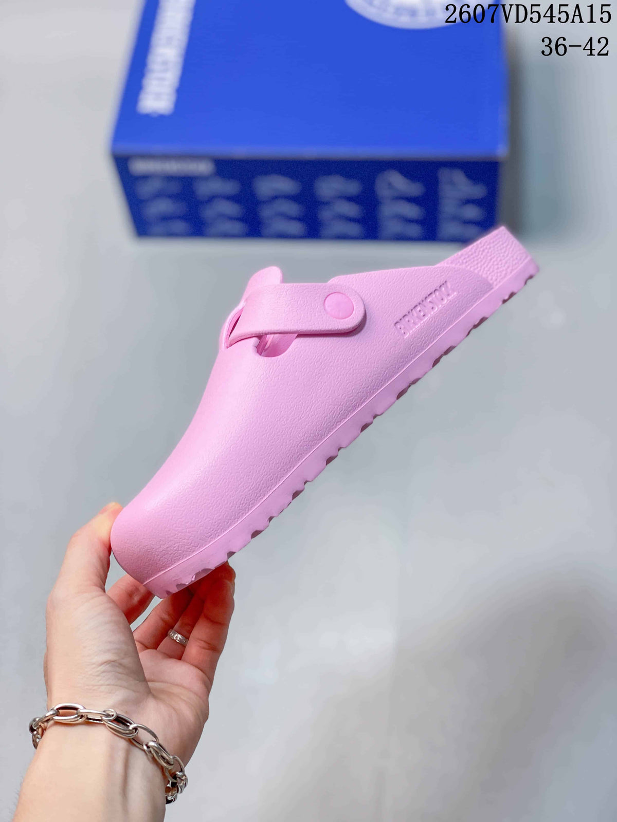 Side profile of the pink closed-toe sandal showing the adjustable buckle strap and textured outsole.
