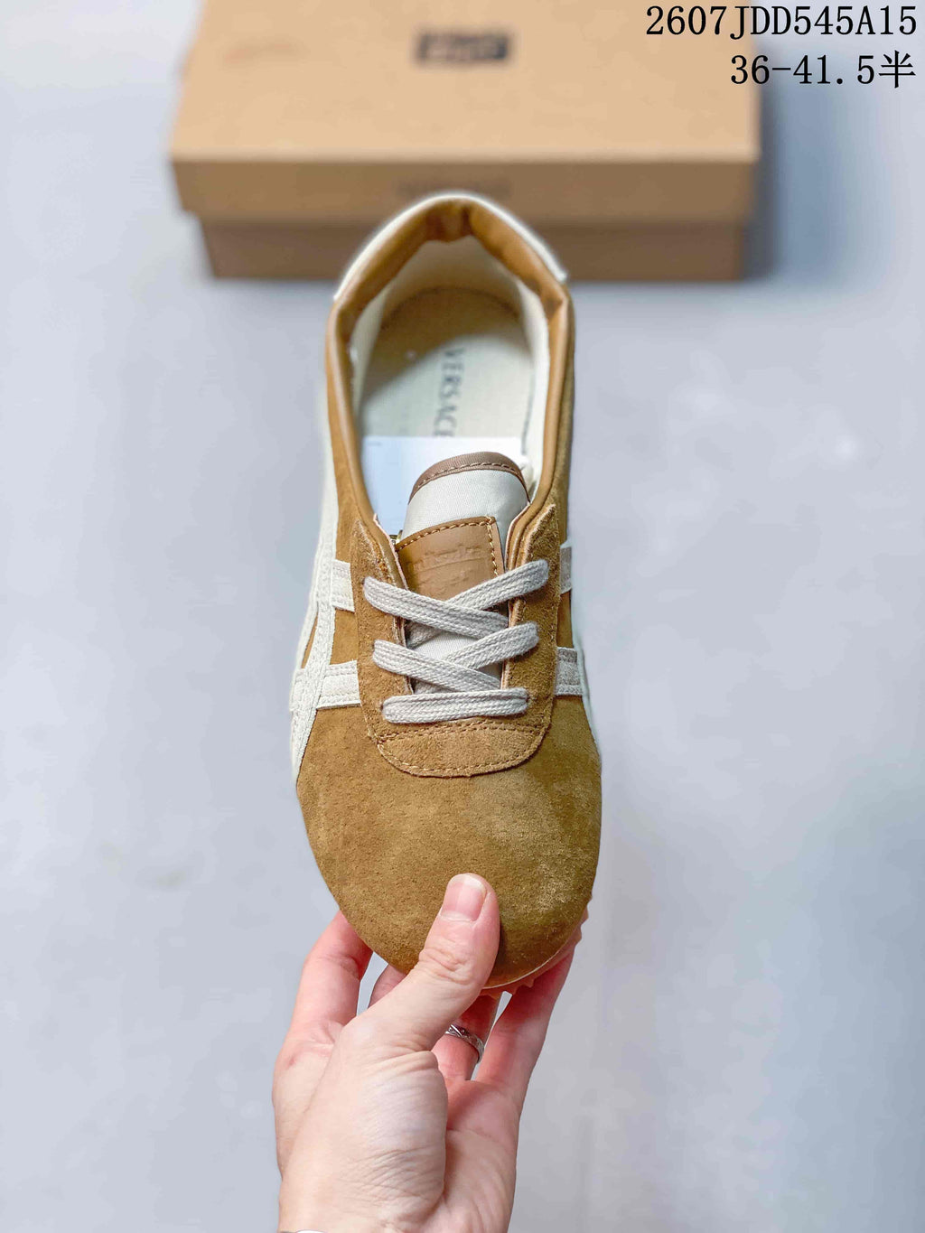 Top view of the sneaker showing the rounded toe, cream laces, tan tongue, and contrasting side panels.