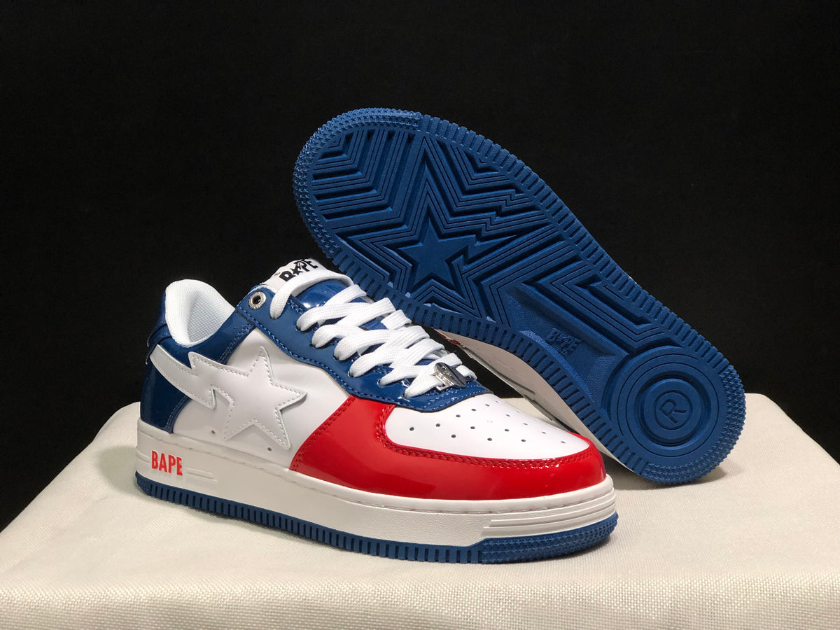 Angled view showing the blue patterned outsole beneath the white, blue, and red sneaker.