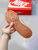 Close view of the gum-colored outsole showing raised geometric tread details and a central Nike design.