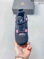 Top view showing the black toe box, laces, pink eyelet details, and mesh tongue panel.