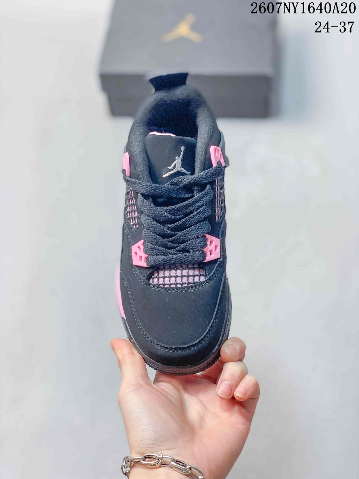 Top view showing the black toe box, laces, pink eyelet details, and mesh tongue panel.