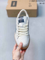 Top view of the sneaker showing the white laces, tongue label, perforated toe panel, and textured toe overlay.