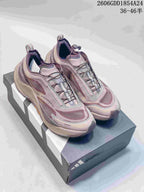 Pair of mauve and gray Adidas Holo Peak low-top trail running shoes on a box