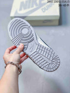 Close view of the gray rubber outsole with circular traction at the forefoot and rectangular tread blocks at the heel.