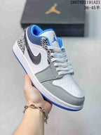Angled close-up showing the white and grey upper, black Swoosh, elephant-print eyestay and blue outsole.