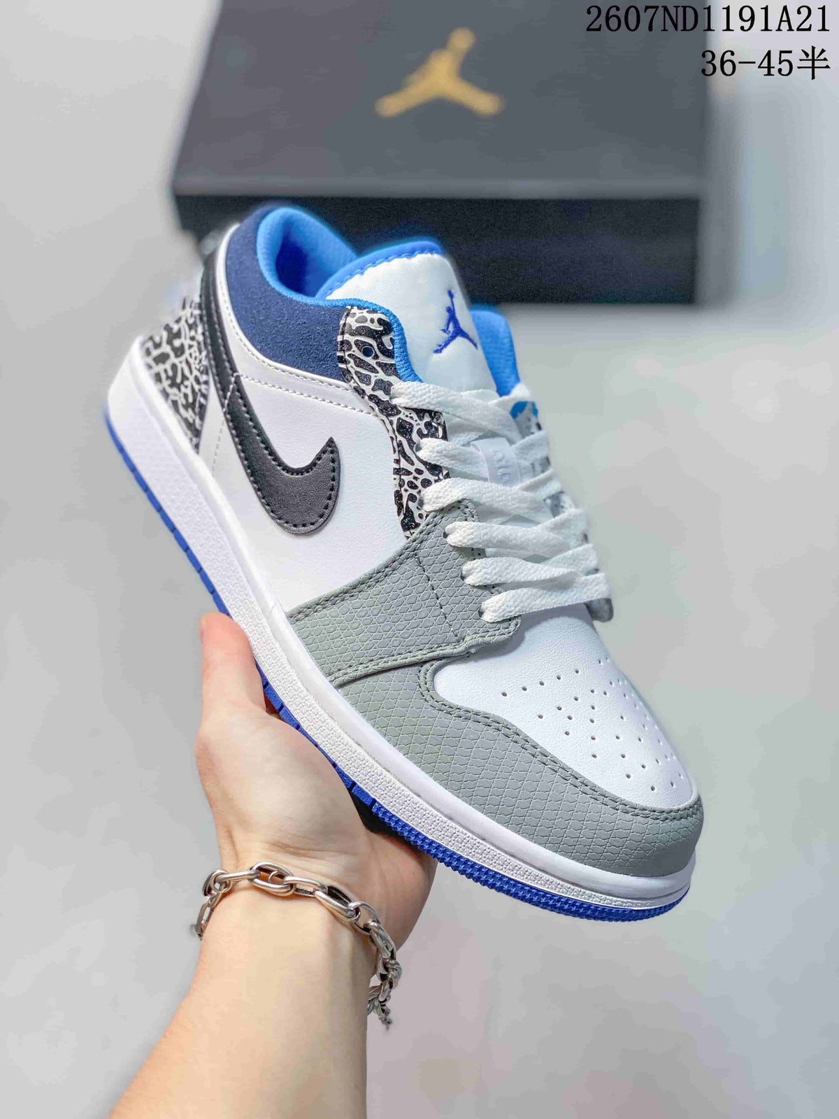 Angled close-up showing the white and grey upper, black Swoosh, elephant-print eyestay and blue outsole.
